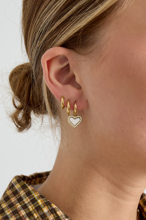 Earrings with dangling mother-of-pearl hearts
